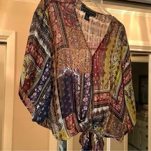 Polly Esther top in a rust and brown print. Material is sheer.